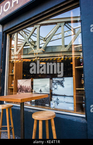 reflection in coffee shop window of  Victorian  railway bridge Stock Photo