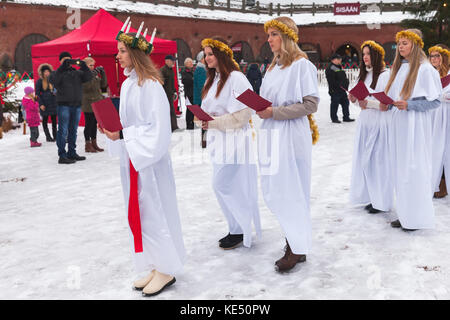 Hamina, Finland - December 13, 2014: choir of young Finnish girls goes to the Christmas fair Stock Photo