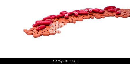 Red vitamins and supplements capsule and iron tablets isolated on white background with copy space and clipping path. Use for topics content about tre Stock Photo