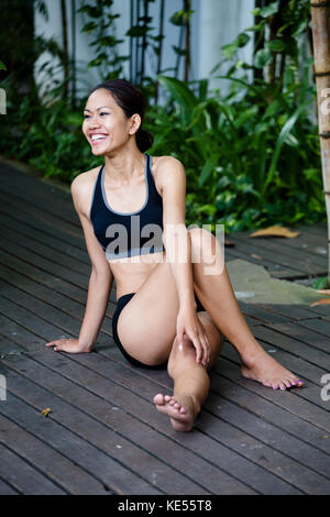 Young Khmer woman exercising outdoors Stock Photo