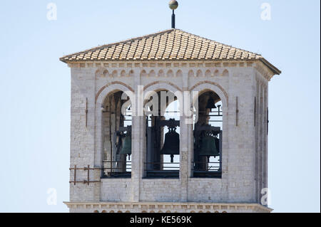 Romanesque bell tower of Franciscan friary Sacro Convento with Upper Church of Basilica Papale di San Francesco (Papal Basilica of Saint Francis of As Stock Photo