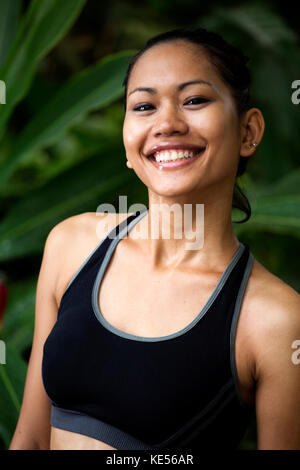 Smiling Asian woman in fitness clothes Stock Photo