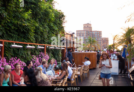 New York City USA - July 13 2015: Tourists and New Yorkers doing an aperitif on the 230 Fifth rooftop. It is the first Rooftop Bar in New York. Stock Photo