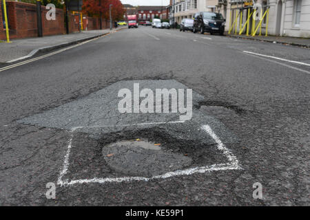 Pothole in road causing misery for motorist Stock Photo