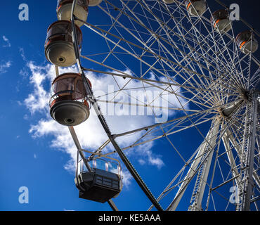 Temporary mobile ferris wheel against a blue sky with a single white cloud located in Southampton England. Stock Photo