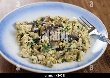 Scrambled eggs with mushrooms served on a plate Stock Photo