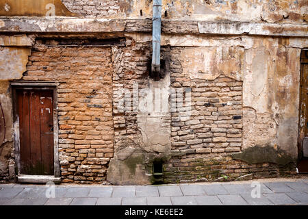 Old brown door of a abandoned house Stock Photo