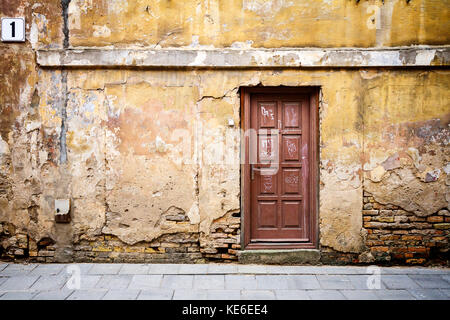 Ancient door of a abandoned house Stock Photo