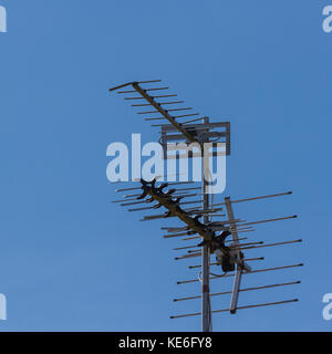 British television aerials against a blue sky Stock Photo