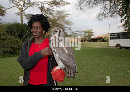 African woman with Verreaux's Eagle owl Bubo lacteus sitting on arm Owl Trust Naivsaha Kenya Stock Photo