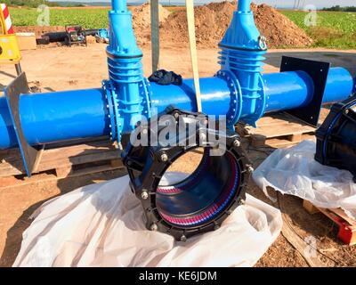 500mm new black eccentric flexible fastener. 500 mm drink water Gate valve joint with screws and nuts to pipe fitting. Piping repair, unit on wooden Stock Photo