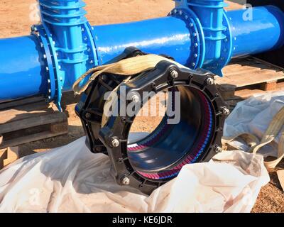 500mm new black special coupler joint unit. 500 mm drink water Gate valve joint with screws and nuts to pipe fitting. Piping repair, unit on pallet Stock Photo