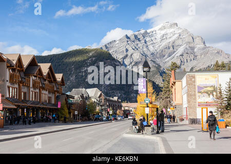BANFF, CANADA - OCT 16, 2017: Busy Banff Avenue in the Banff National Park with Cascade Mountain in the background. The townsite is a major Canadian t Stock Photo