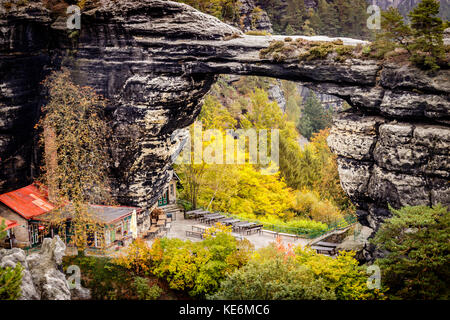 The Prebischtor is a narrow rock formation located in the Bohemian Switzerland in the Czech Republic. Picture taken on a stormy golden october day Stock Photo
