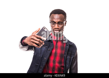 Smiling dark-skinned young man making selfie on white background Stock Photo