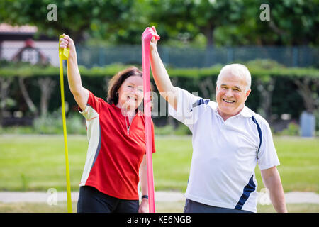 Happy Senior Couple Doing Work Out In Park Stock Photo