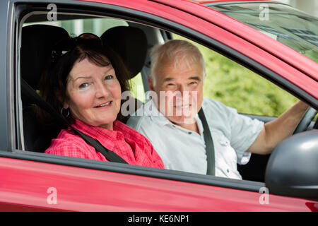 Smiling Senior Couple Sitting In A Car Stock Photo