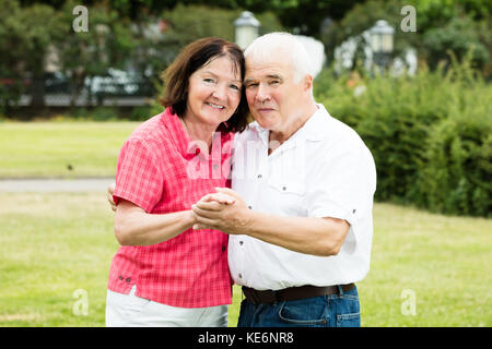 Portrait Of Happy Senior Couple Holding Hands Stock Photo