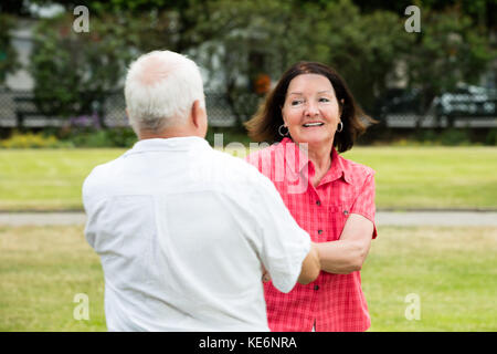 Smiling Senior Couple Having Fun In Park Stock Photo