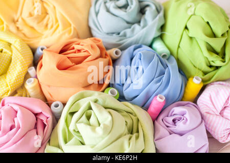 Colored fabric folded in the form of rose flowers. Stock Photo