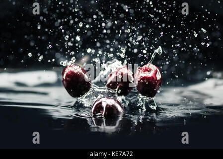 ripe cherries falling in water Stock Photo - Alamy