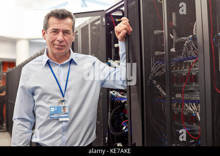 Portrait confident male IT technician in server room Stock Photo