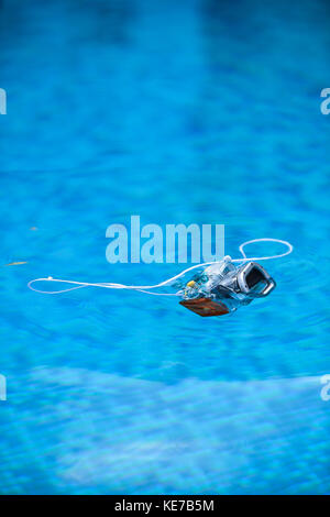 Underwater photo camera housing floating in a swimming pool Stock Photo