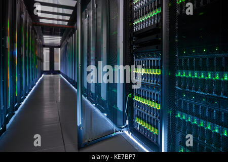 Glowing, open panel in dark server room Stock Photo