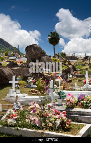 The Seychelles, Mahe, Victoria, Mont Fleuri Cemetery, granite boulders amongst graves Stock Photo