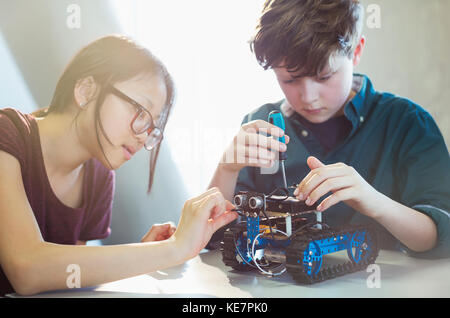Students assembling robotics in classroom Stock Photo