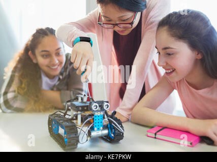 Girl students assembling robotics in classroom Stock Photo