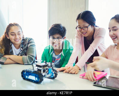 Students programming and testing robotics in classroom Stock Photo