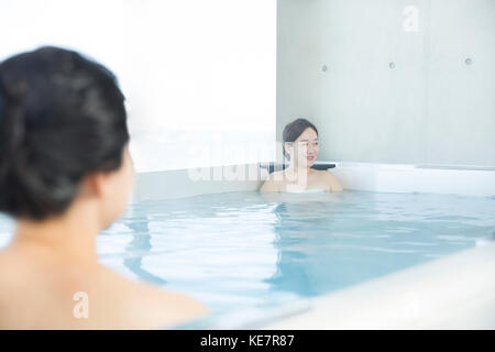 Two smiling middle aged women resting at spa Stock Photo