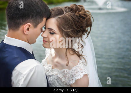 Bride and groom near a lake