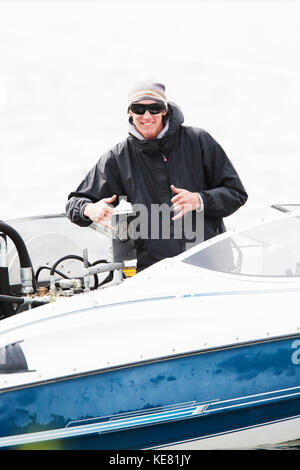 Man On A Motorboat Giving Paragliding Instruction, Alaska, USA Stock Photo