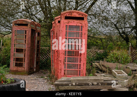 Abandoned red telephone boxes in reclamation yard. Stock Photo