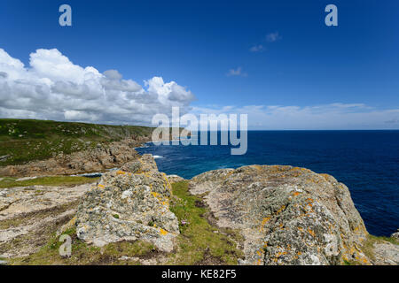 Granite rock formations on cliffs above Porth Loe cove and looking out at Gwennap Head near Porthgwarra in Cornwall Stock Photo