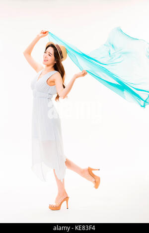 Young smiling woman in summer dress and hat fluttering cloth Stock Photo