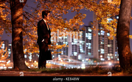 Lifestyle of businessman tired and gloomy in city at night Stock Photo