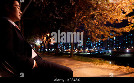 Businessman tired and gloomy in city at night Stock Photo