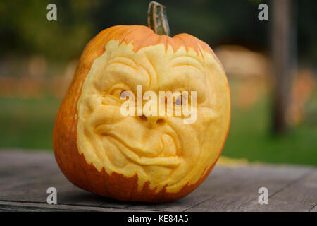 Artistically carved face in a pumpkin for Halloween decoration Stock Photo