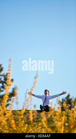 Businessman taking a break at park during daytime Stock Photo