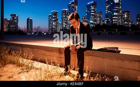 Lifestyle of businessman tired and gloomy in city at night Stock Photo