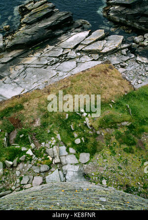 Looking down from top of the broch wall above the entrance, showing paved path to doorway, and proximity to sea. Mousa broch, Shetland, Scotland Stock Photo