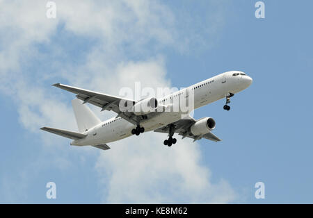 Unmarked passenger jet airplane in flight Stock Photo