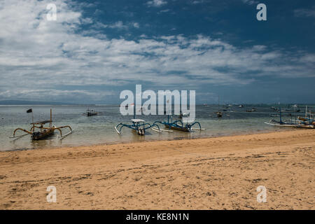 Traditional balinese dragonfly boat on the beach. Jukung fishing boats on Sanur beach, Bali, Indonesia, Asia. Stock Photo