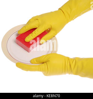 Yellow gloved hands washing a plate with a red sponge. On white background. Clipping path included. Stock Photo