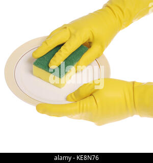 Yellow gloved hands washing a plate with a yellow sponge. On white background. Clipping path included. Stock Photo