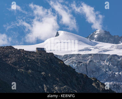 MOIRY VALLEY, SWITZERLAND - Cabane de Moiry mountain hut on ridge, Moiry glacier mountain landscape, in the Pennine Alps in the canton of Valais. Stock Photo