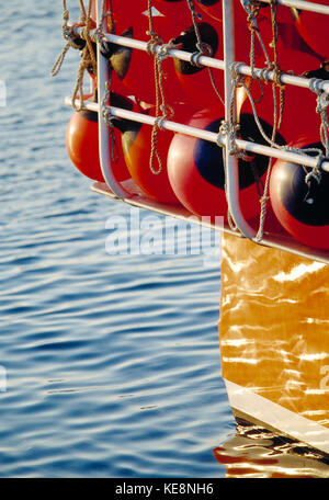 Guernsey. Close up of buoys at stern of fishing boat.